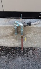 Outdoor water meter and valve connection mounted on concrete foundation